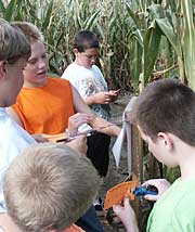 Kids are challenged with agriculture trivia questions at 12 posts throughout the corn maze at Knollbrook Farm in Goshen, Indiana